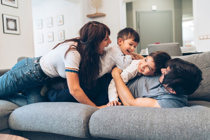 Family playing on couch